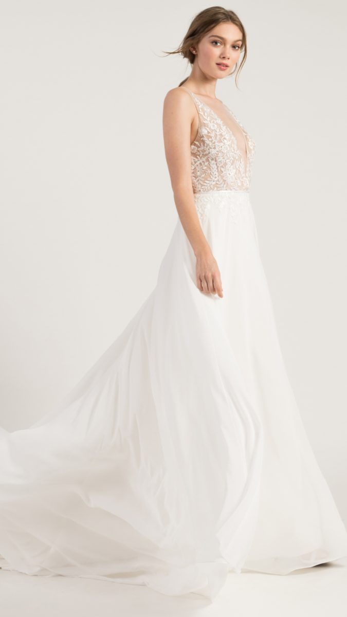 A line wedding dress with lace top and spaghetti straps and flowy skirt