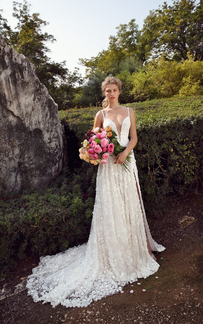 Ballgown wedding dress spaghetti strapwith high slit up the leg and a deep v plunging neckline