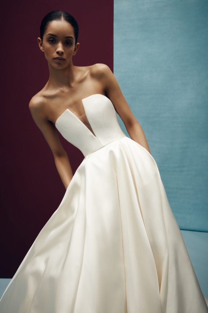 Strapless ivory wedding dress with ball gown skirt and pockets