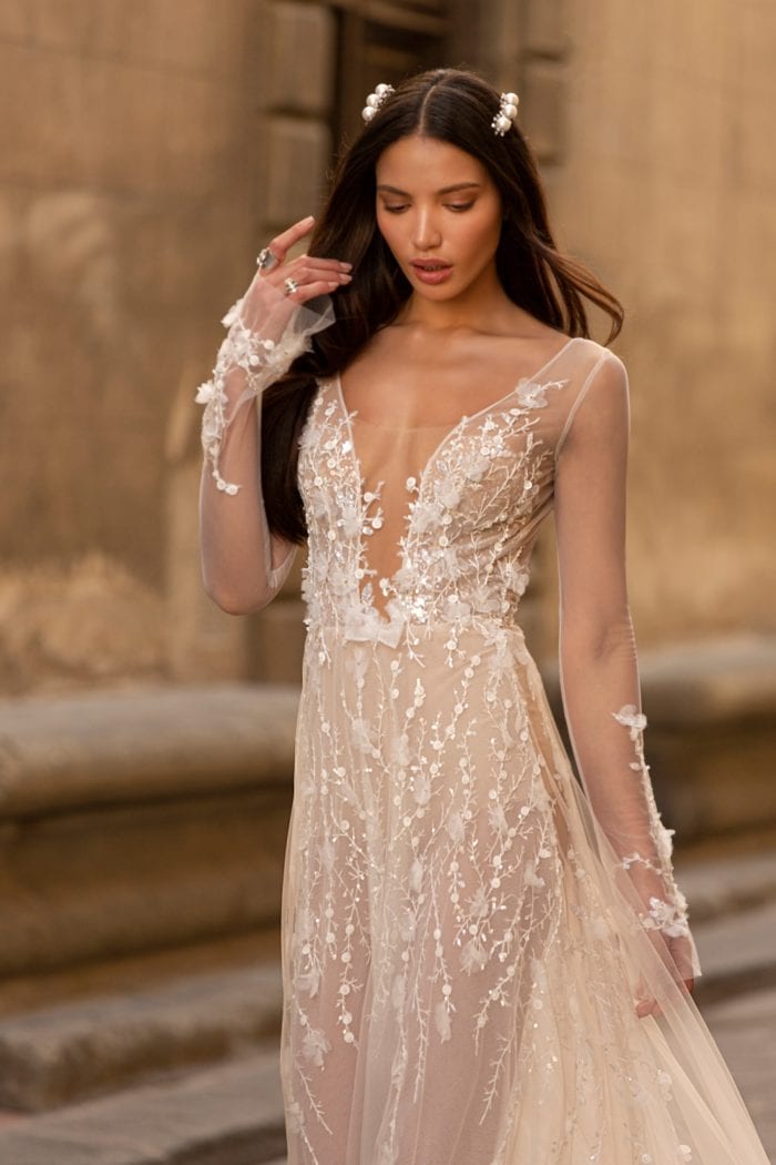 Long sleeve sheer embellished designer bridal gown with plunge neckline