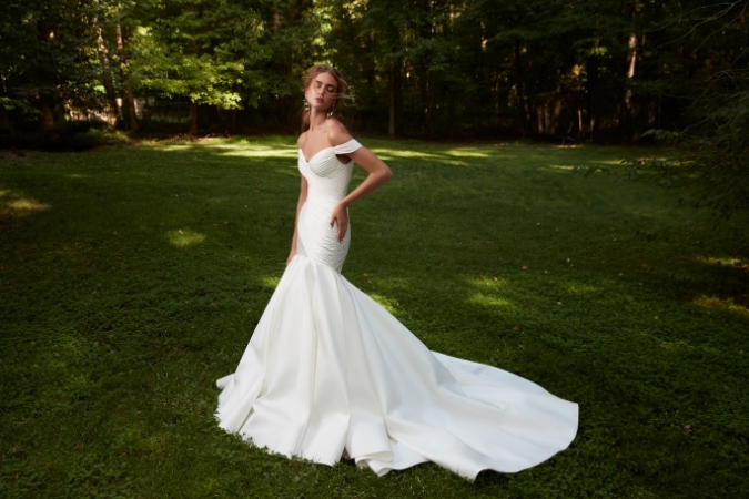 Dramatic off the shoulder bridal gown with mermaid fit and flare skirt