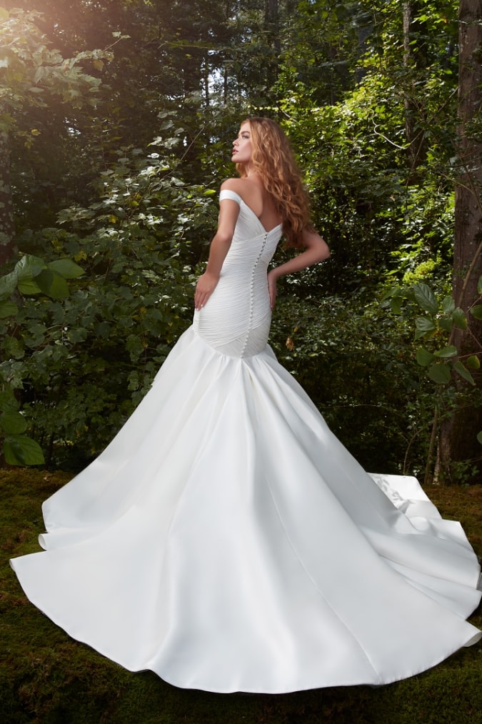 Off the shoulder wedding dress with fitted silhouette and flared meremaid hemline