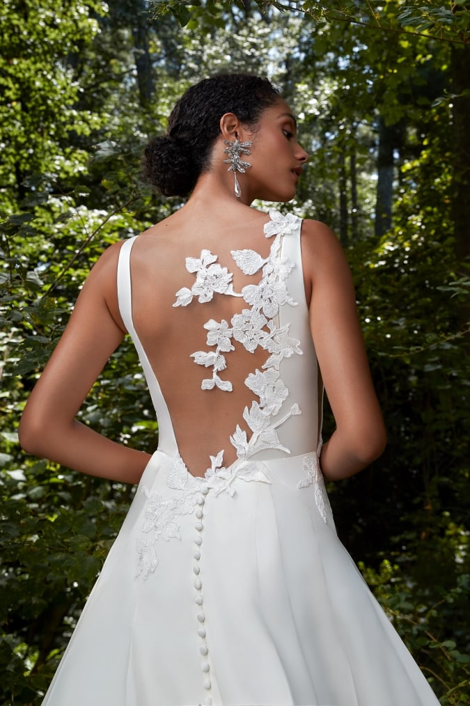 Bridal gown with floral applique details on the back designed by Anne Barge