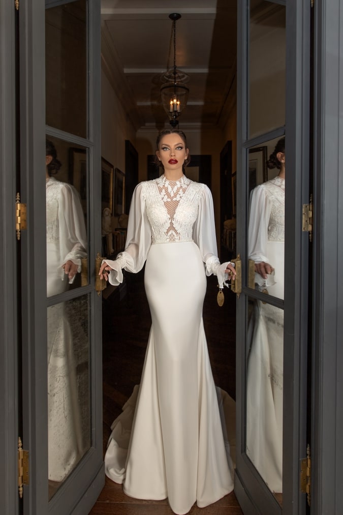 Woman wearing a long sleeve deisgner wedding dress