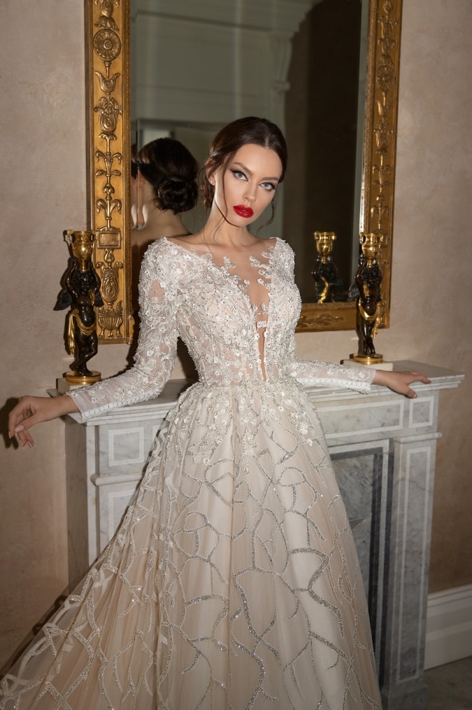 Woman wearing a long sleeve beaded wedding dress