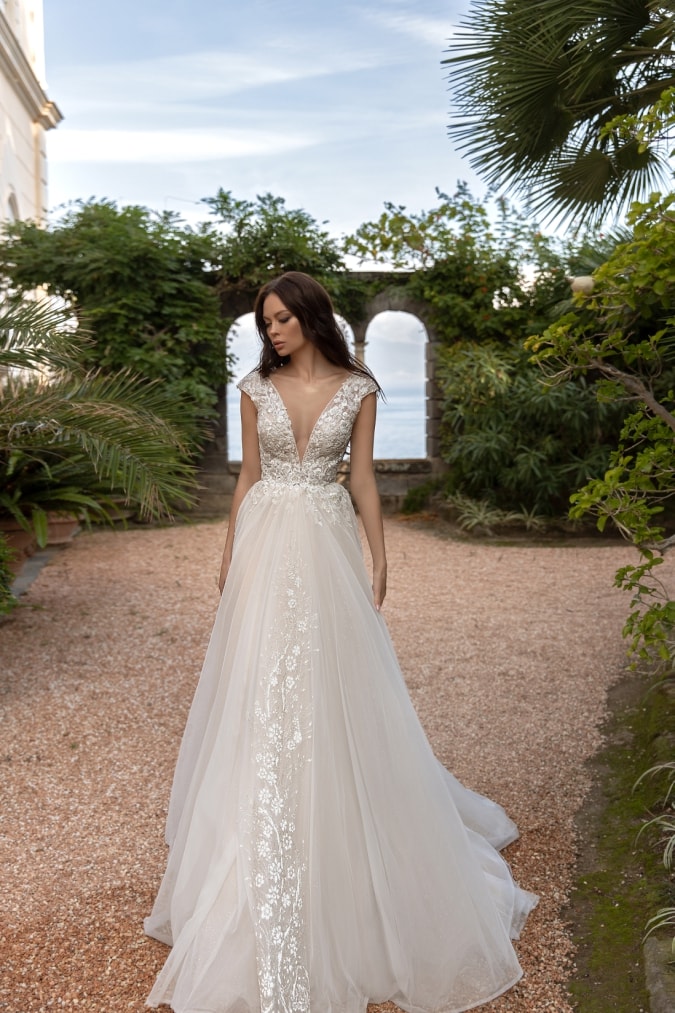 Plunging neckline on a short sleeve lace and tulle wedding dress