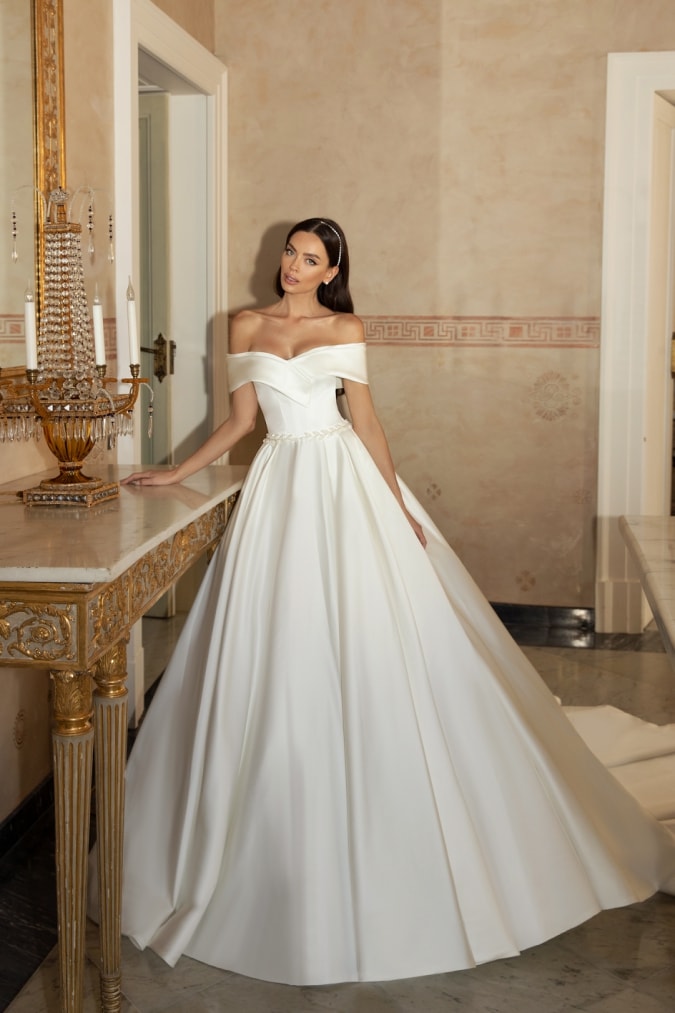 Off the shoulder ball gown wedding dress on a model