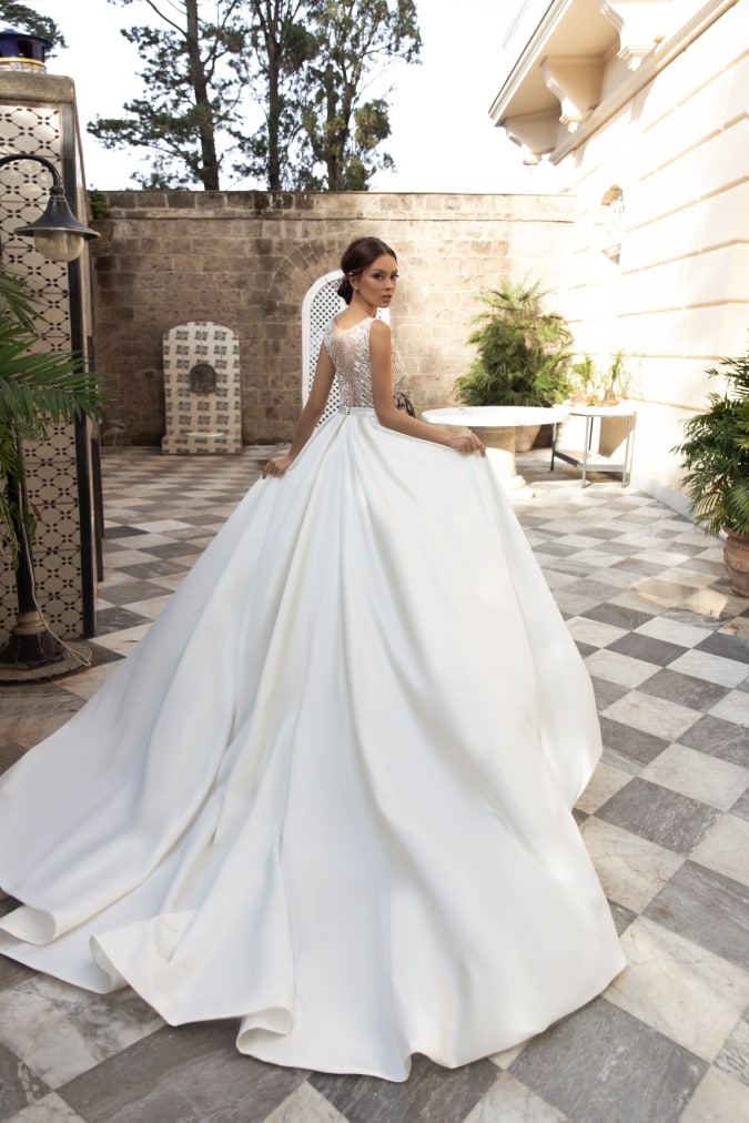 Wedding dress with a long ivory full ballgown skirt and train