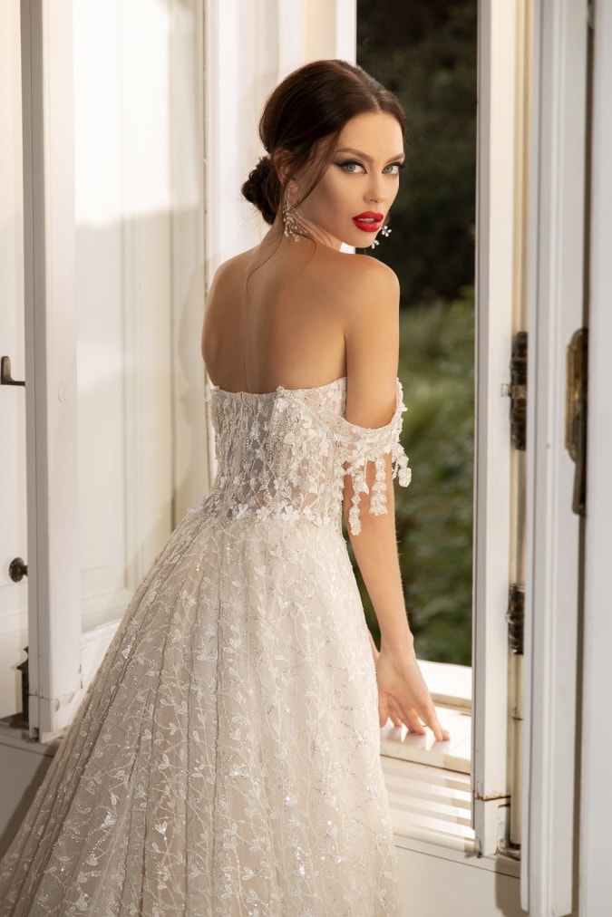 Model in a off the shoulder lace designer bridal gown