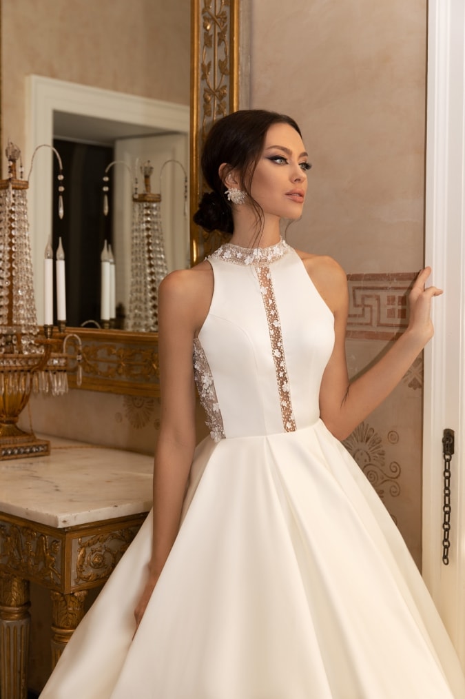 Model in a high neck sleeveless ballgown wedding dress