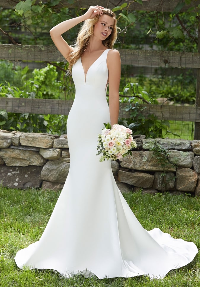 Wedding dress with plunging V neckline, wide straps, side cutouts, deep back, simple mermaid 