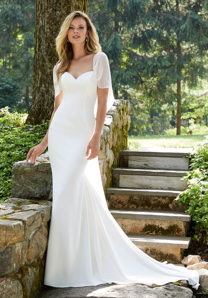 Ivory crepe fit to flare gown with detachable chiffon drape