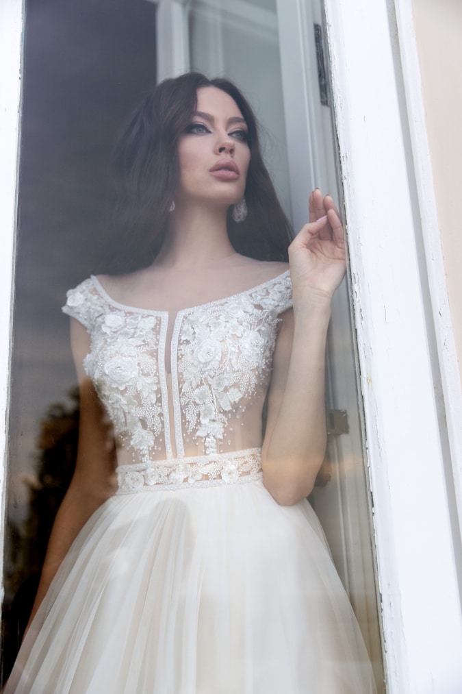 Illusion bodice wedding dress with corset cap sleeves and floral detail