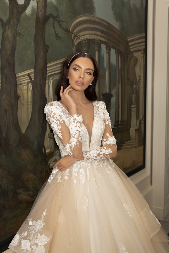 Plunging v neck wedding dress with long sleeves and full tulle overskirt with tiers