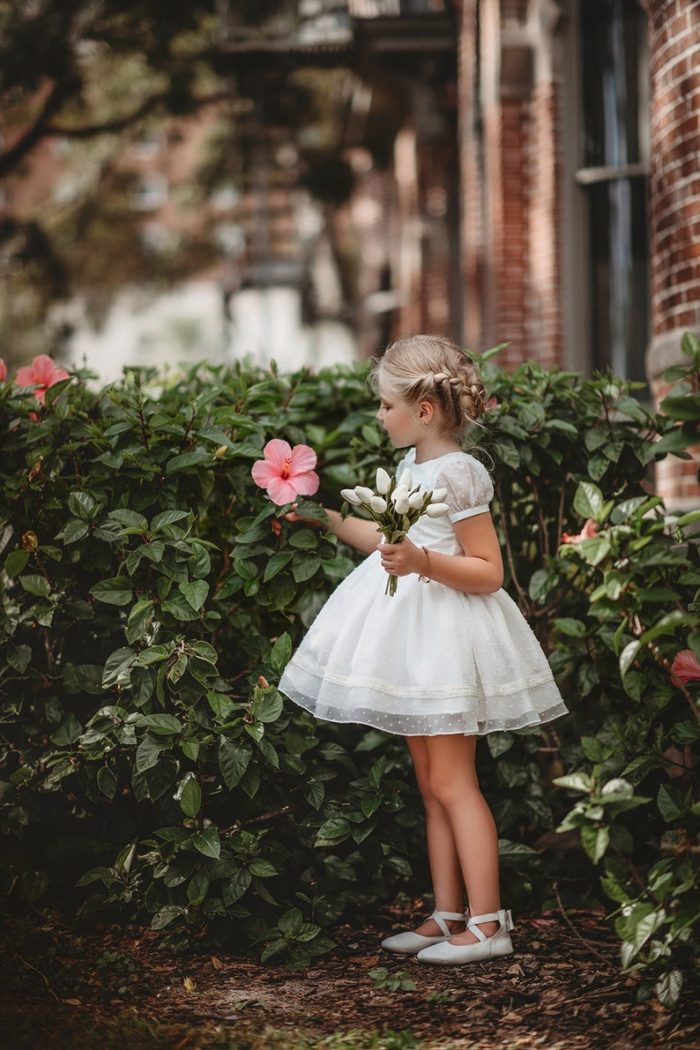 Young girl wearing a short sleeve white dress 