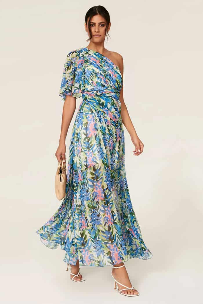 one shoulder floral maxi dress with blue and multicolor pattern shown on a model and available to rent