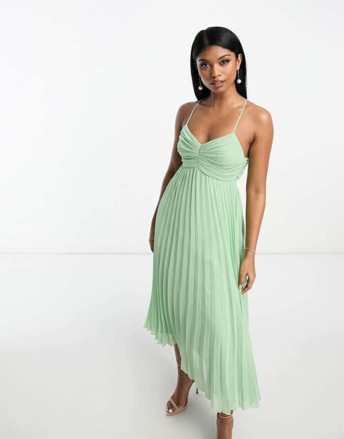 Spaghetti strap light green dress with pleats shown on a model
