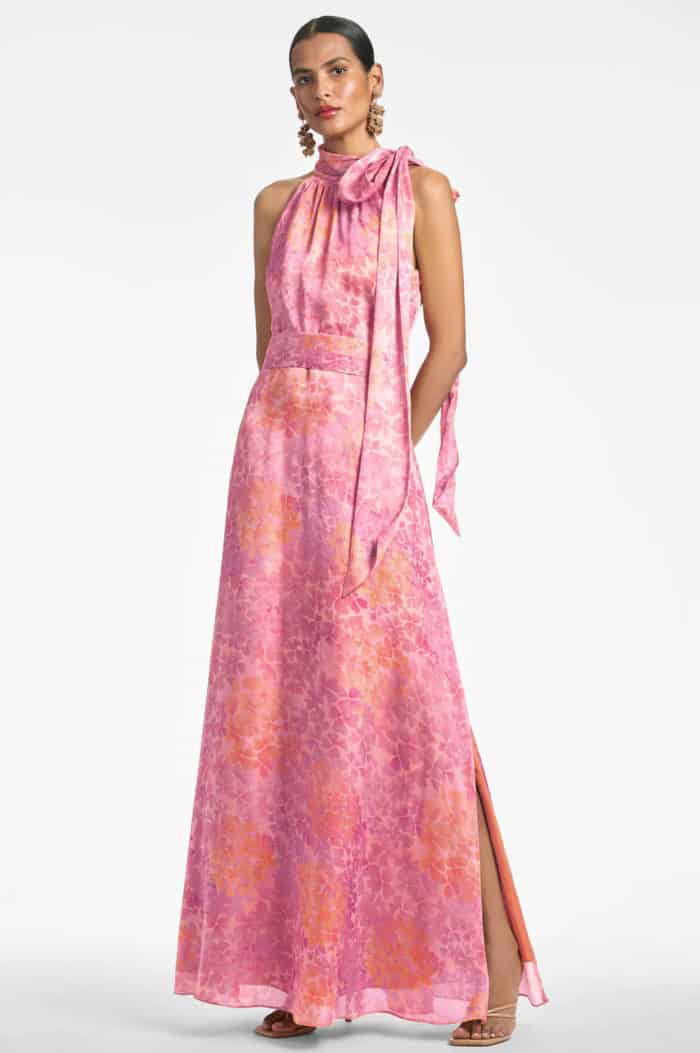 Coral pink sleeveless gown with a subtle floral print