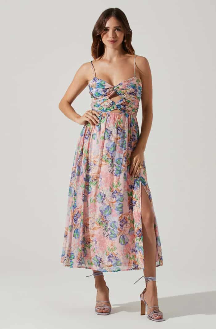Floral midi dress with thin straps and cut outs shown on model
