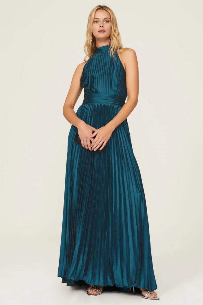 Teal sleeveless pleated formal gown with high neckline on a model