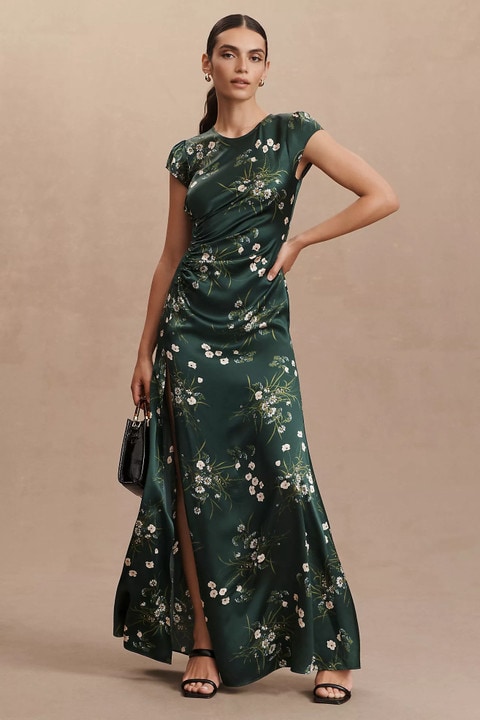 Dark green maxi dress with white flowers shown on a model
