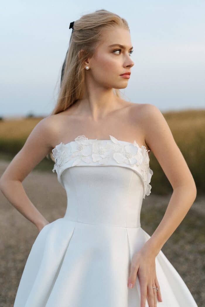 Close up image of model with foldover strapless ballgown wedding dress