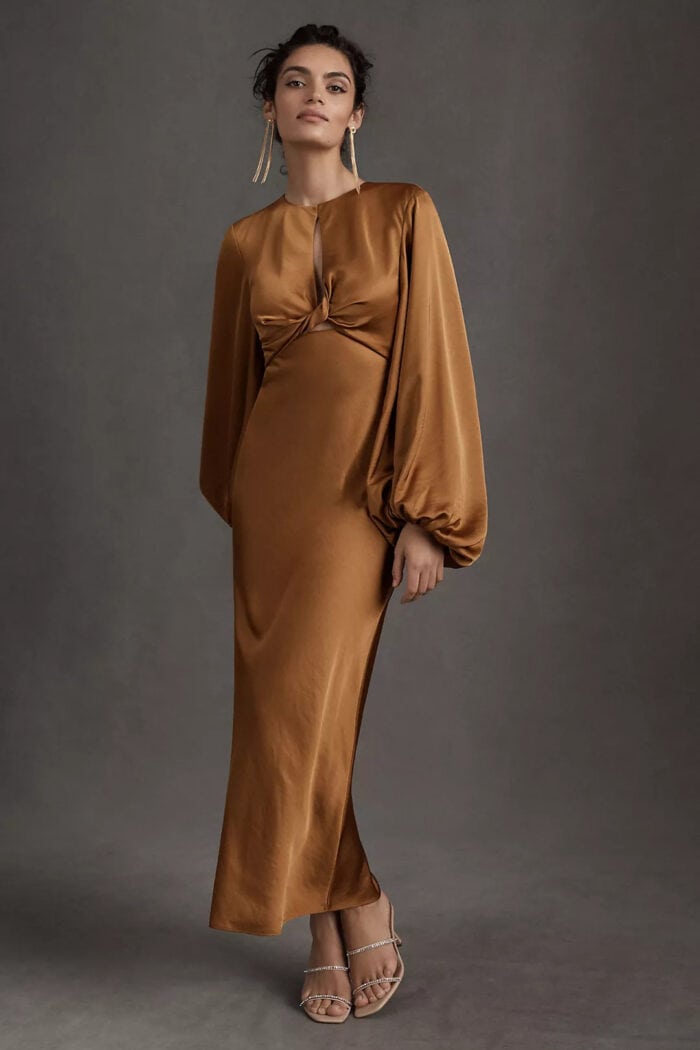 Product image of a model wearing a bronze gold long sleeve satin maxi dress with balloon sleeves.