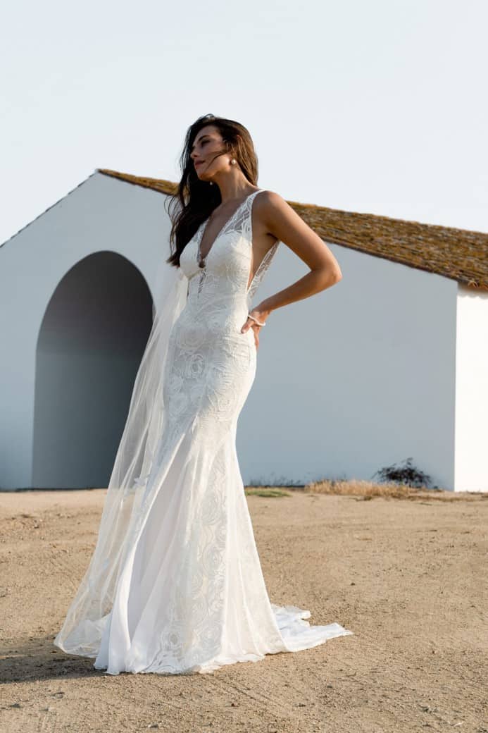 Model wearing a v neck wedding dress called Dahlia in a photo shoot in Portugal